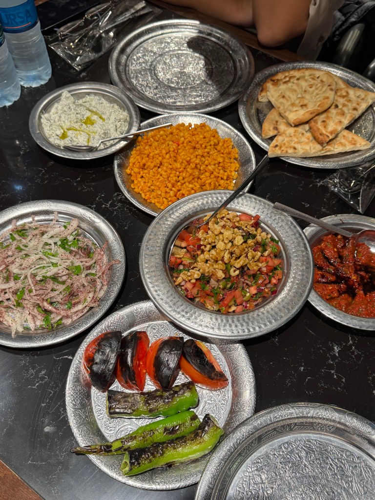Lots of Turkish food on plates on a table