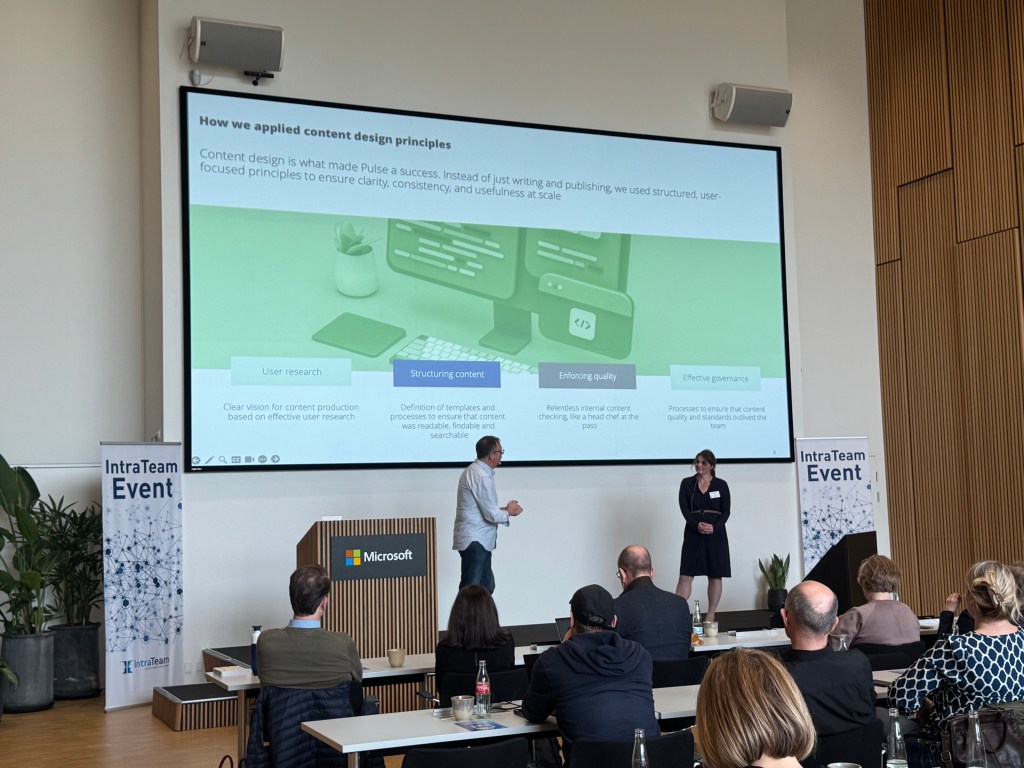 Jonathan Phillips and Sabine Arnold on stage at IntraTeam