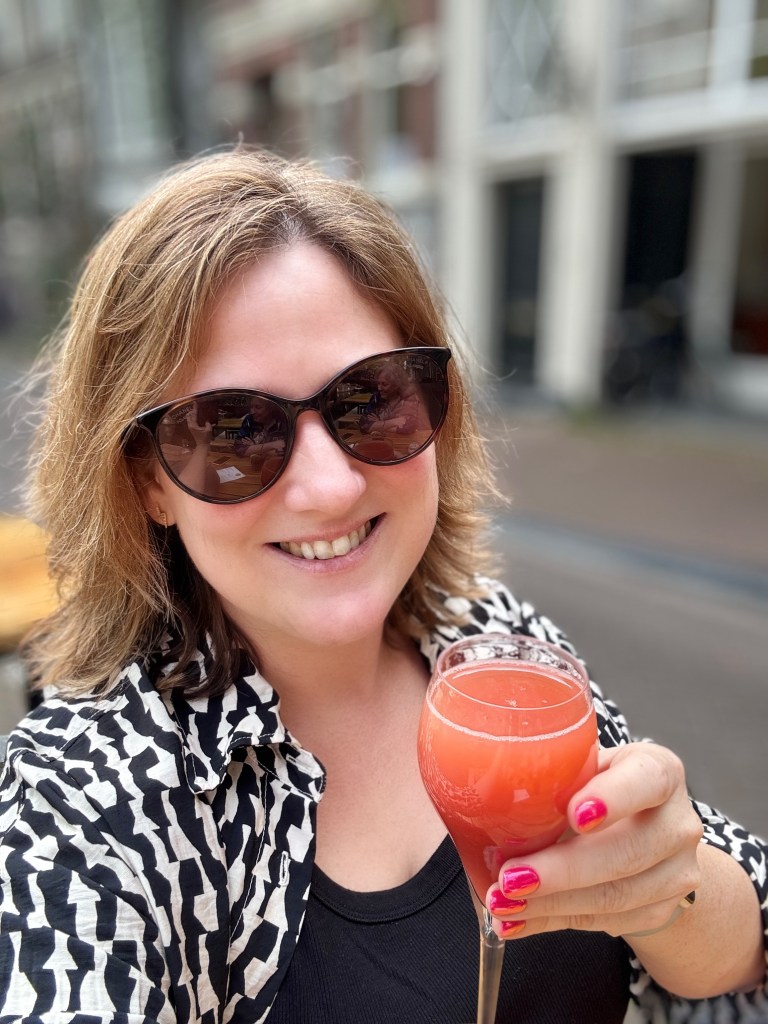 A woman (me)with brown hair, holding a glass on Mimosa
