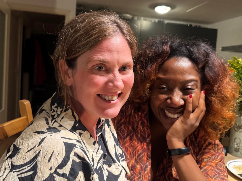 Two women, obviously a little worse for wear after a night drinking wine and chatting in the sun.