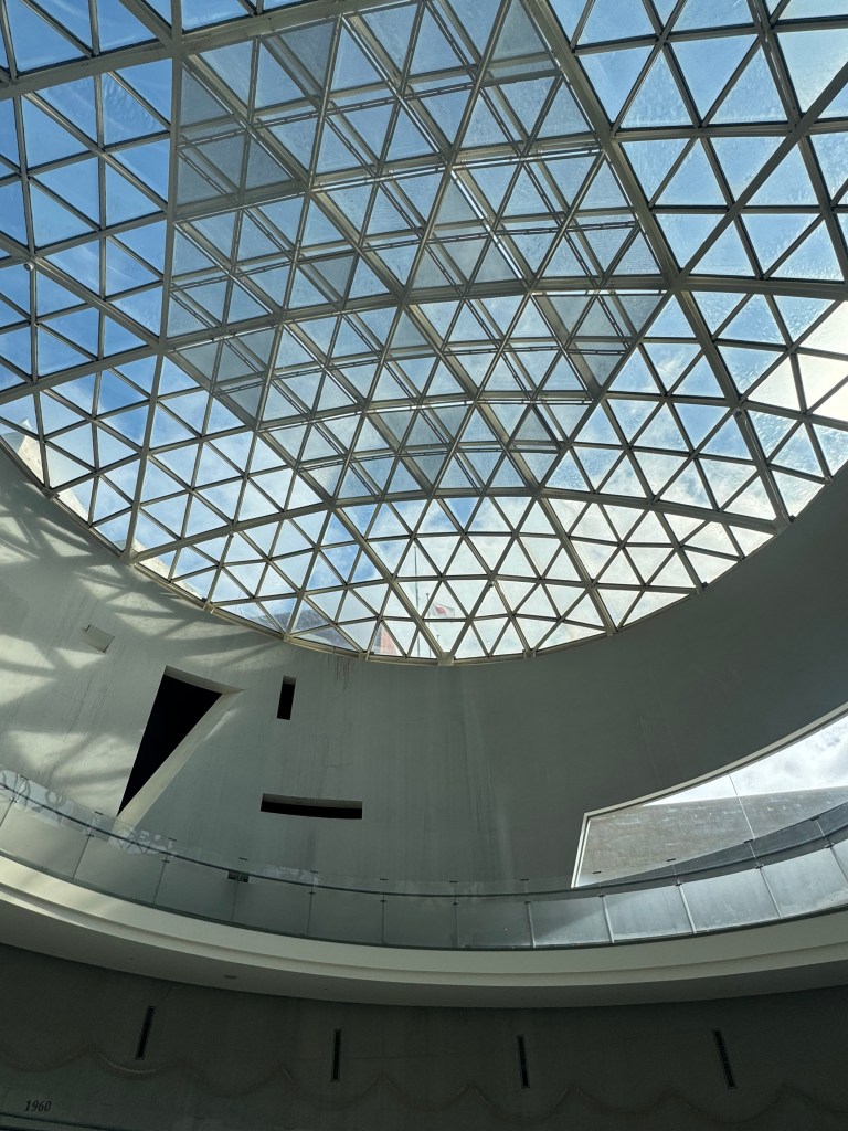 View of a skylight with a geometric glass design, allowing sunlight to illuminate the interior space.